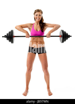 Full length front view of attractive young woman lifting barbell on white background. Stock Photo