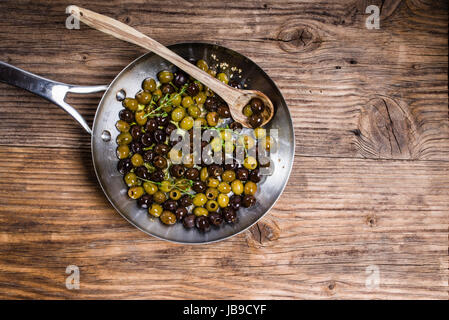 Fresh olives being cooked in a skillet Stock Photo