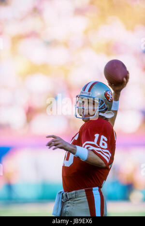 San Francisco 49ers quarterback Joe Montana (R) and Steve Young speak to  each other while wide receiver Jerry Rice (C) holds the 1989 Super Bowl  trophy after an audience of nearly ten