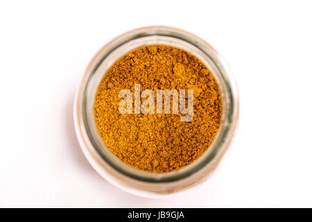 Curry powder in a glass pot Stock Photo