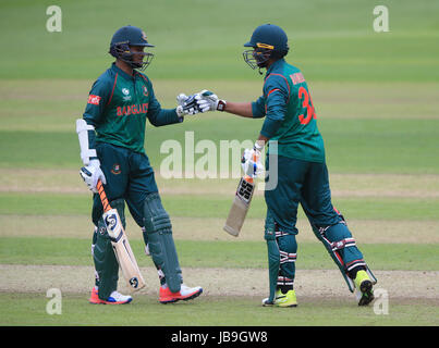 Bangladesh's Shakib Al Hasan (left) and Mahmudullah touch gloves during the ICC Champions Trophy, Group A match at Sophia Gardens, Cardiff. Stock Photo