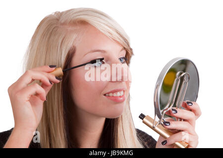 Young woman making up herself - isolated on white background Stock Photo