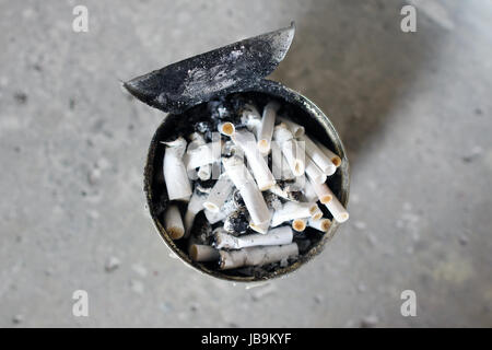 Heap of cigarette butts in an old can Stock Photo