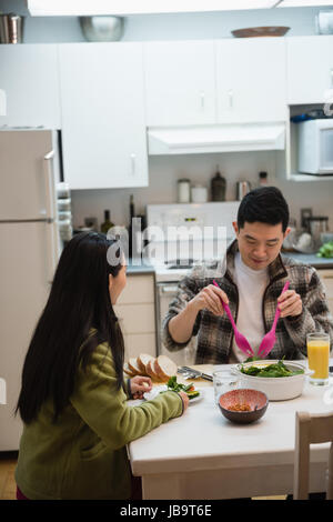 Couple having breakfast in kitchen at home Stock Photo