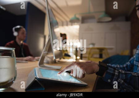 Executive using digital tablet in office Stock Photo