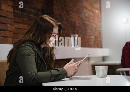 Smiling female executive using digital tablet in office Stock Photo