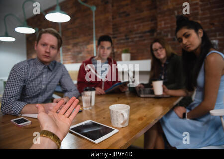Executives discussing during meeting in office Stock Photo