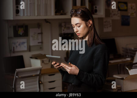 Female executive using digital tablet in office Stock Photo