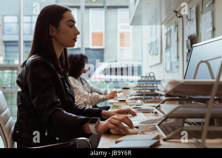 Female executive working on computer at desk in office Stock Photo