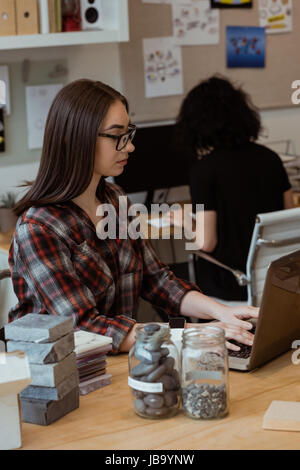 Female executive working on laptop at desk in office Stock Photo