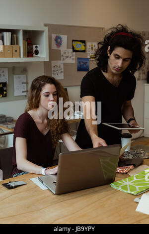 Business colleagues working together at desk in office Stock Photo