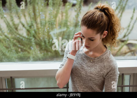 Female executive talking on mobile phone in office Stock Photo