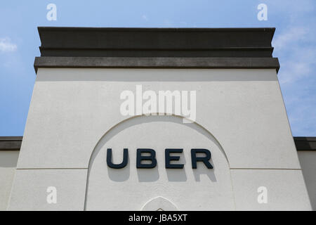 A logo sign outside of a Uber Technologies regional office in 