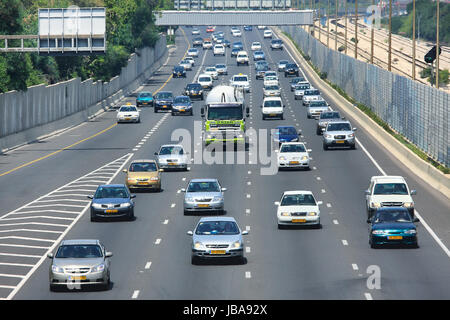 TEL AVIV - MAY 07: Traffic flow on Ayalon highway during rush hour at sunny hot day. Highway 20 aka Ayalon Highway is multi-lane highway and major intracity freeway in Tel Aviv, Israel on May 07, 2010. Stock Photo