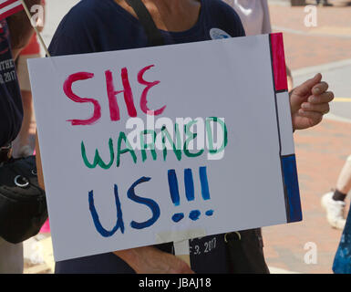 Asheville, North Carolina, USA - June 3, 2017: Female demonstrator holds a political sign at a March For Truth saying 'She Warned Us!' in reference to Stock Photo