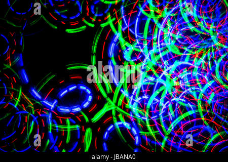 Lines and circles of colored light forming chaos Stock Photo