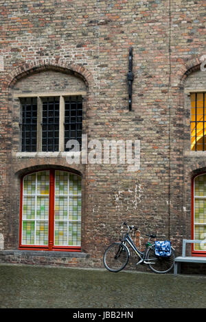 Bicycle parked next to medieval building; Bruges, Belgium Stock Photo