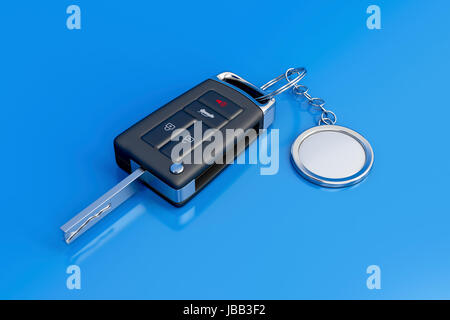 Car key with metal keyring on blue shiny background Stock Photo
