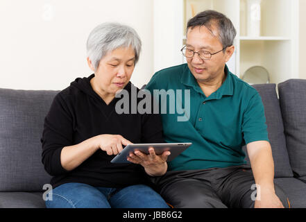 Asia old couple using tablet Stock Photo