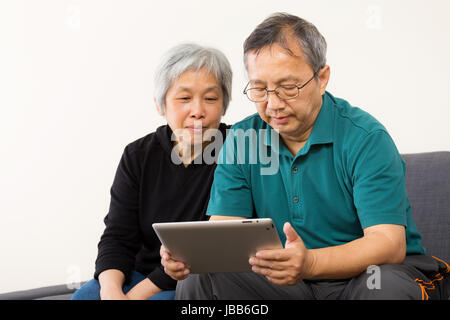 Asia couple using tablet at home Stock Photo