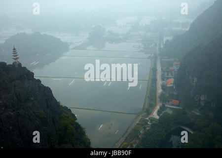 View of temple, limestone karsts and rice paddies from Mua Cave Lookout, Trang An Landscape Complex (UNESCO World Heritage Area), Ninh Binh, Vietnam Stock Photo