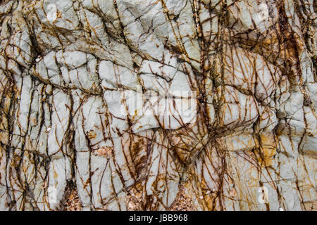Detailed textures and patterns of a cliff by the beach in Thailand Stock Photo