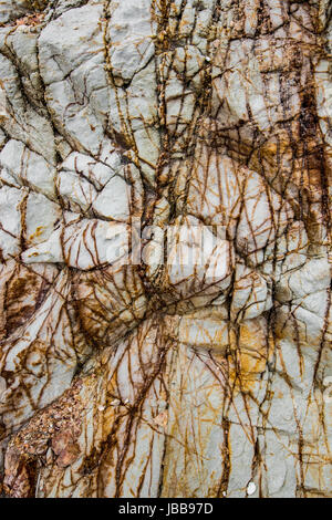 Detailed textures and patterns of a cliff by the beach in Thailand Stock Photo