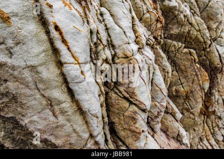 Detailed textures and patterns of a cliff by the beach in Thailand Stock Photo