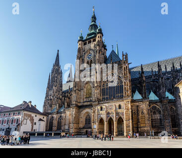 PRAGUE - MARCH 13: Tourist at Saint Vitus Cathedral on March 13, 2014 in Prague. This cathedral is an excellent example of Gothic architecture, the biggest and most important church in the country Stock Photo