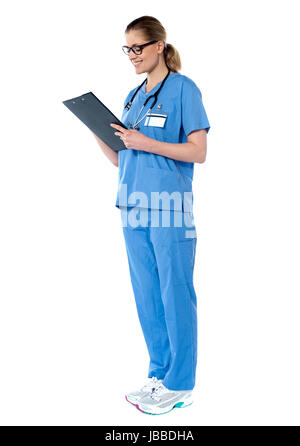 Female surgeon looking at reports isolated on white background Stock ...