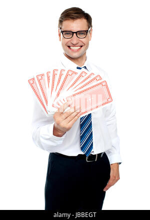 Cheerful man holding up playing cards. All on white background Stock Photo