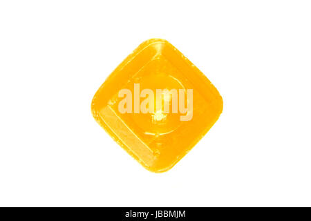 one orange flavoured hard candy isolated on the white background Stock Photo