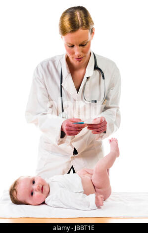 Adult female pediatrician wearing a white coat and a stethoscope and checks with clear in digital thermometer body temperature of the infant, isolated against a white background. Stock Photo