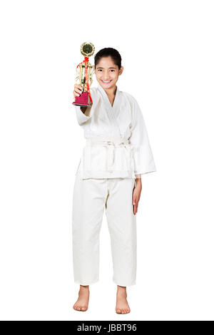 1 Indian Teenager Girl Martial Arts karate Student Showing Winning Trophy Standing On White Background Stock Photo