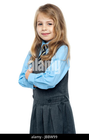 Beautiful schoolkid smiling. Posing with arms folded. Stock Photo