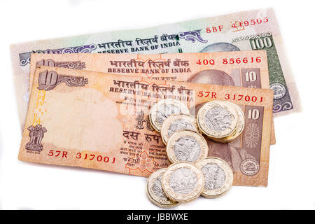 British pound coins laid on Indian Rupee notes Stock Photo