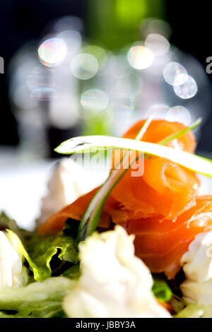 Smoked salmon rolls with cream cheese, closeup shot Stock Photo