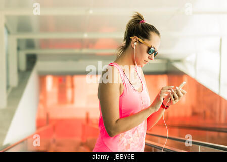 Caucasian woman in hotel descending to gym area to train and stay fit. Stock Photo