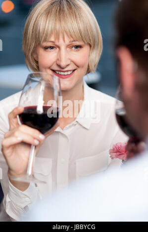 Couple cherishing memories while drinking red wine in restaurant Stock Photo