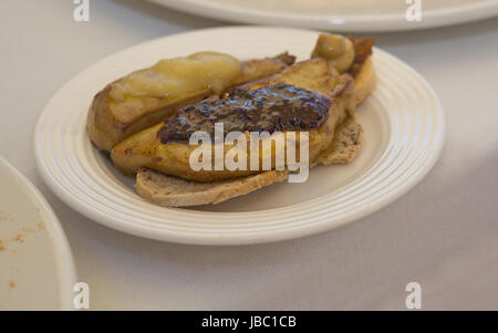 Hot grilled foie gras over bread slices with apple and strawberries jam on the top Stock Photo
