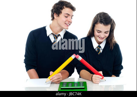 School boy copying from his fellow student during examination Stock Photo