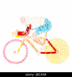 Doping drugs and pills in the shape of a road bicycle racer on a bike. Stock Photo