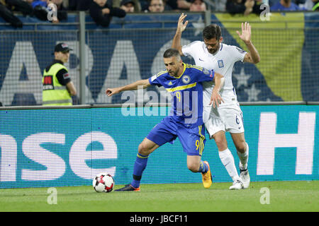 Zenica, Bosnia and Herzegovina. 9th June, 2017. Vedad Ibisevic (L) of Bosnia and Herzegovina (BiH) vies with Alexandros Tziolis of Greece during the 2018 FIFA Russia World Cup Qualifiers Group H match between Bosnia and Herzegovina (BiH) and Greece in Zenica, Bosnia and Herzegovina, June 9, 2017. The match ended with a 0-0 draw. Credit: Haris Memija/Xinhua/Alamy Live News Stock Photo