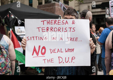 Cardiff, UK. 10th June, 2017. Poster that says 'no deal with the DUP'. Calling for Conservative Prime Minister Theresa May to resign, in conjunction with other protests taking place across the UK, austerity campaigners gathered under the Aneurin Bevan stature in Cardiff City centre, where there were speeches by activists and a march across Queen Street. Taz Rahman/Alamy Live News Stock Photo