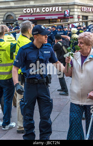 Warsaw, Poland - June 10th, 2017: Police officers remove anti-government protesters from streets of the Old Town during the 86th monthly anniversary of the Smolensk crash in April, 2010. Stock Photo