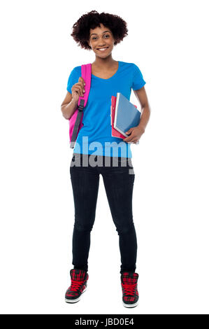 Curly haired college student isolated against white background. Full length portrait. Stock Photo