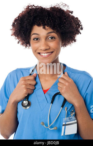 Smiling curly haired lady doctor with stethoscope around her neck. Stock Photo