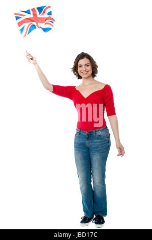 Full length portrait of a patriotic woman waving national flag Stock Photo