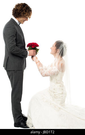 Gorgeous bride kneeling down and proposing handsome guy Stock Photo