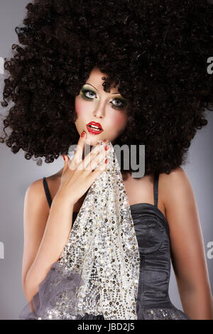 Futurism. Fanciful Girl in Huge Unusual Black African Frizzy Wig Stock Photo